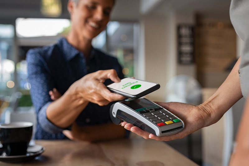 Woman making payment using smartphone