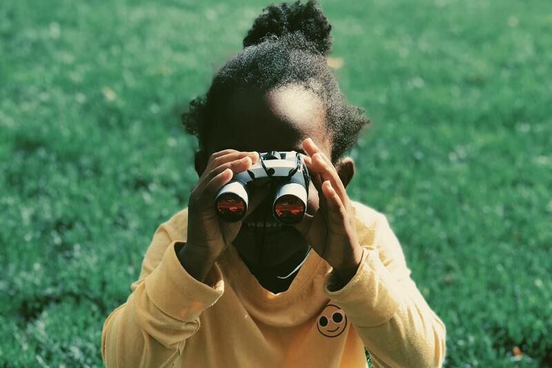 Young girl using binoculars