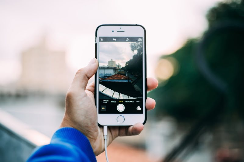 Man taking photo with iPhone