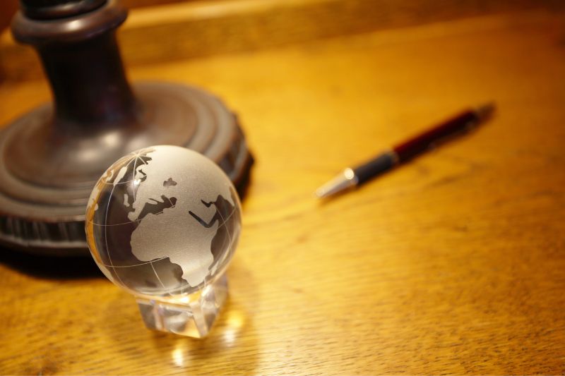 Transparent globe and a pen on a table