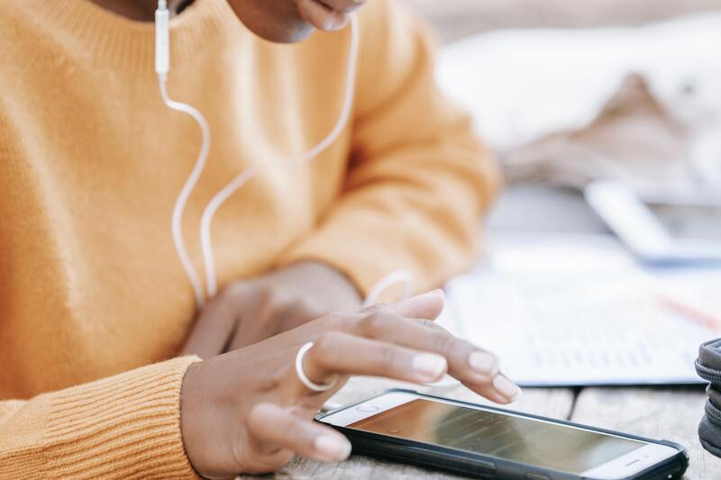 Girl typing on a phone while studying