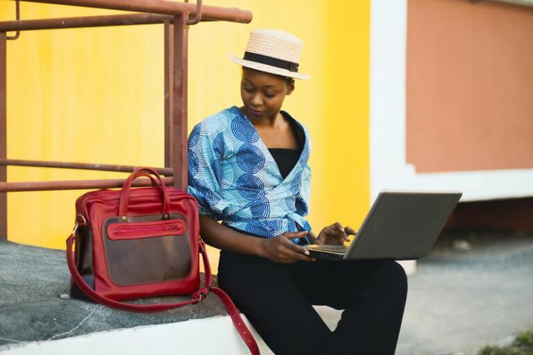Woman with a travel bag and a laptop