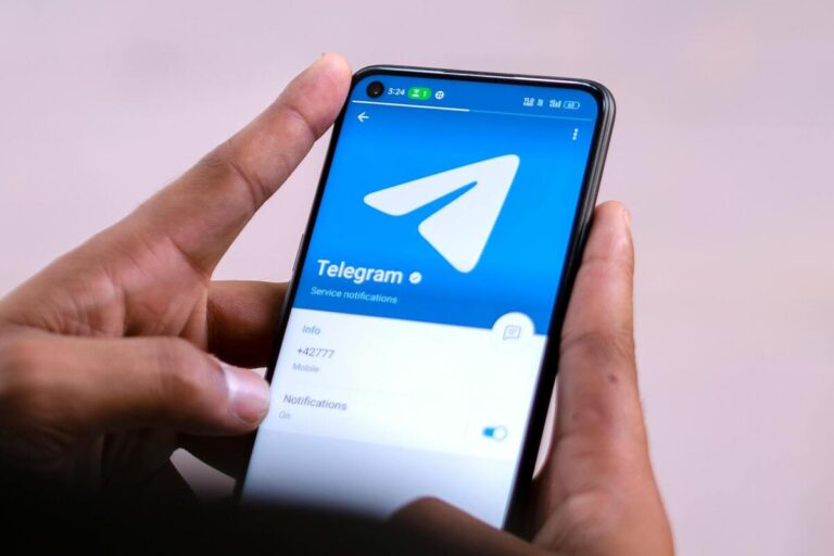 Man using telegram app on iphone