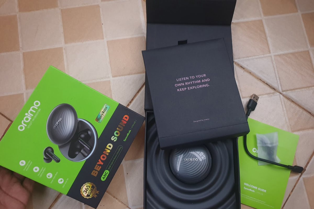 Unboxed earbuds and accessories on the floor